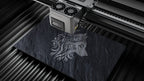 Aliencell X1 40W diode laser engraver with air assist engraving decorative lion design on black slate
