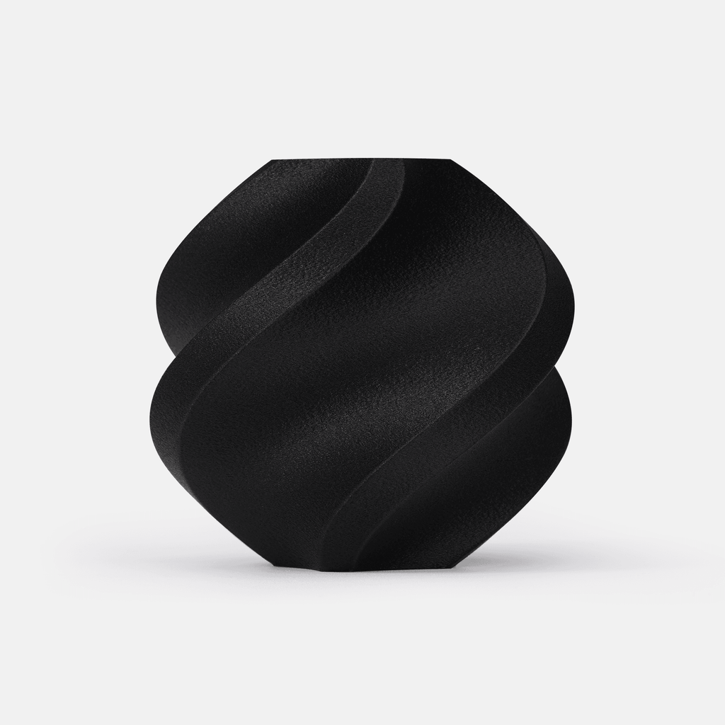 Black Bambu Lab PA6-CF carbon fiber filament 1kg spool, front view on gray background