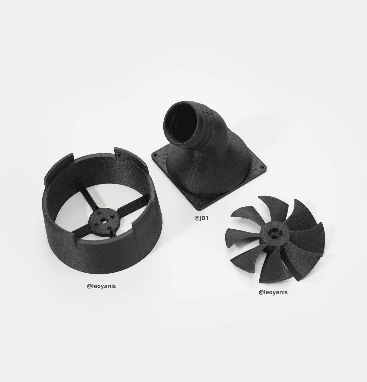 Bambu Lab PET-CF filament spool components: black housing, nozzle, and dual fans on white background