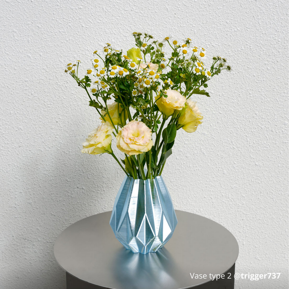 Bambu Lab PETG translucent filament displayed in decorative blue vase with yellow flowers and daisies
